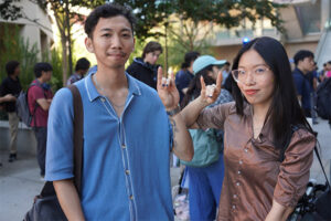 Two students holding a ZOT sign